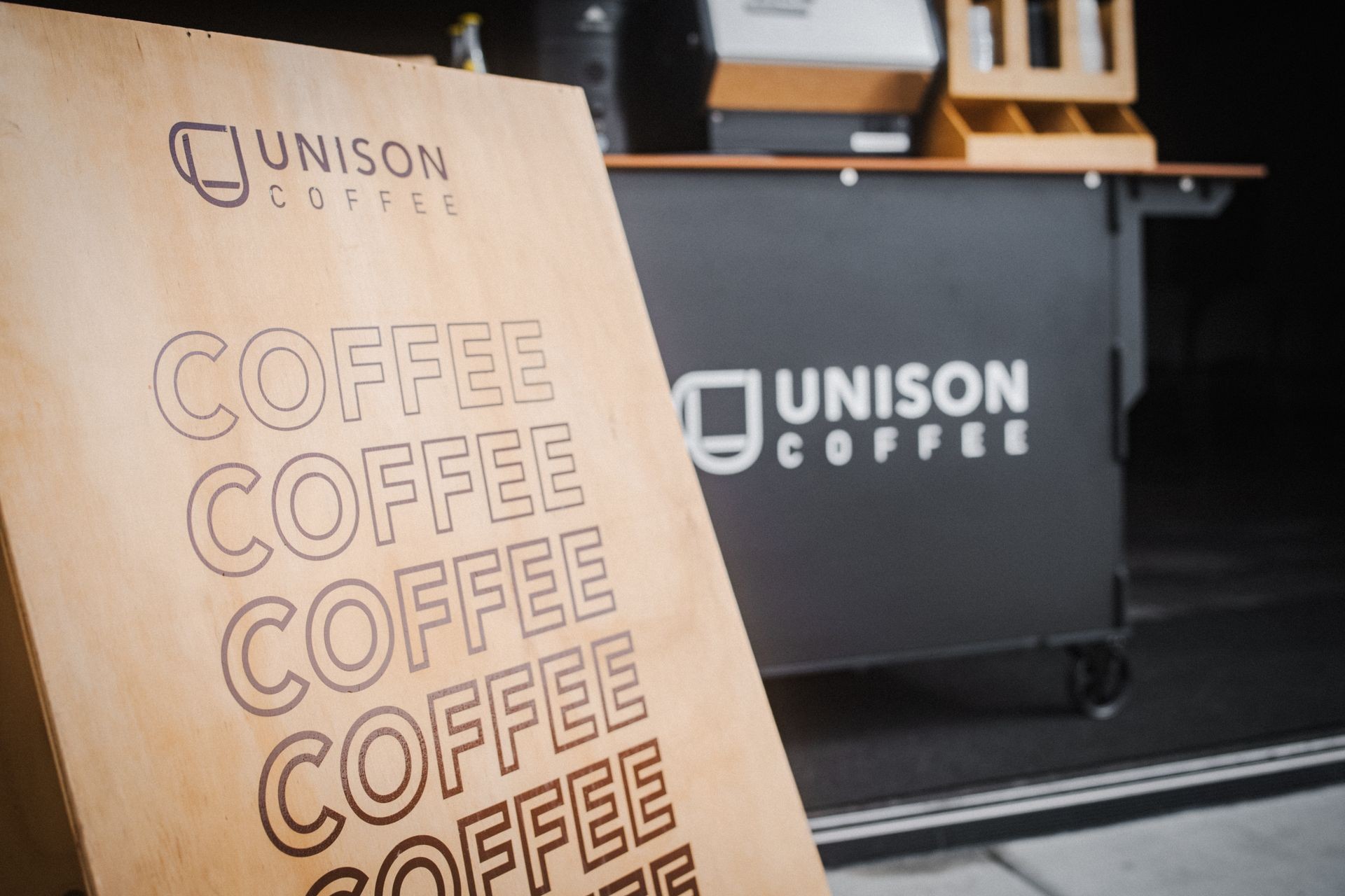 Unison Coffee wooden sign and countertop with coffee theme.